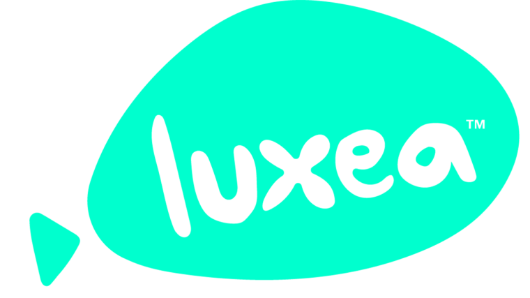 A Turquoise Geometric Speech Bubble Shape With The Word &Quot;Luxea&Quot; In Lowercase, White, Rounded Letters Inside It. The Speech Bubble Has A Small Triangular Tail On The Left Side. A Small Trademark Symbol (™) Is In The Top-Right Corner Of The Bubble, Representing Acdsee Luxea Pro'S Video Editor License.