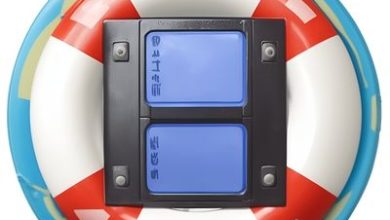 A Circular Pool Float With Red And White Stripes Surrounds A Black Mount Holding Two Blue, Rectangular Buttons. The Float Appears To Have A Teal Border, And The Buttons Are Labeled With Text And Symbols, Possibly For Functions Like Khanpc Or Video Recovery.